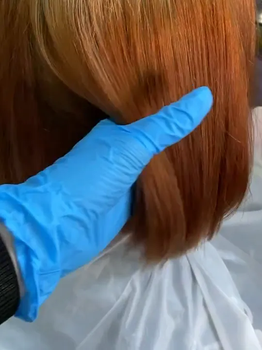 At work in the studio: the red is out, the hair at the in-between copper stage, a gloved hand